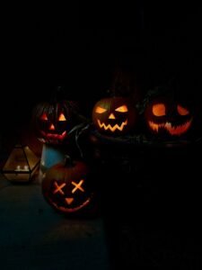 carved out halloween pumpkins glowing in dark