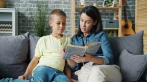 mother and son reading together on sofa