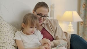 mother and daughter reading a book together indoors